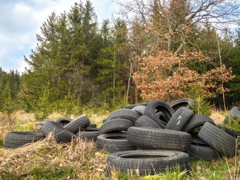 Tire dump next to forest Stock Photos