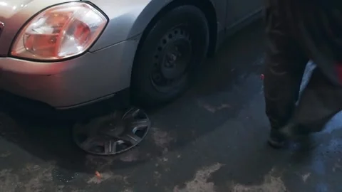 Tire fitting with the replacement of the wheel of the old car is gray. Mechanic Stock Footage 164648614