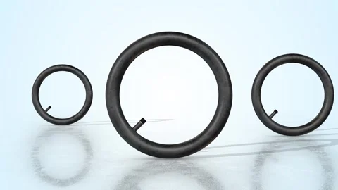 Tire Inner Tubes on a Light Reflective Floor. Stylized Vehicles Inner Tubes 3D. Stock Footage 304456948