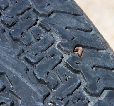 Tire with a nail Stock Photos