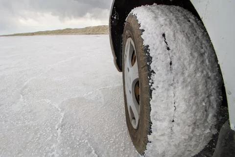 Tire picking up lots of white stuff from the road Stock Photos