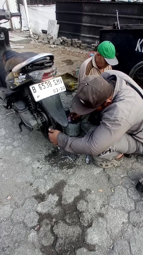 A tire repairman is checking the condition of a tire. Bekasi, June 14, 2026. Stock Footage 339544343