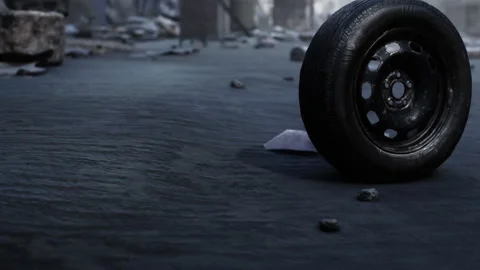 Tire rests on worn street surrounded by debris in urban area Stock Footage 345064112