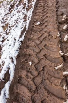 Tire track in the muddy ground Stock Photos