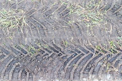 Tire track pattern in wet mud and grass Stock Photos
