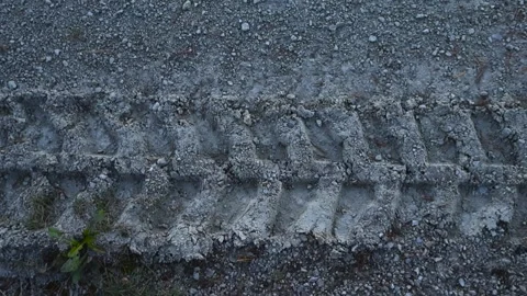 Tire tracks in sandy and gray colored dirt or mud. Stock Footage 318356315