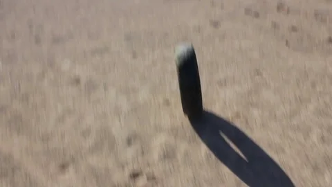 The tire from the wheel rolls on the sand Stock Footage 82453844