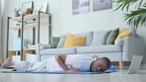 Tired African Man doing Pushups on Yoga Mat at Home Stock Footage 154719936