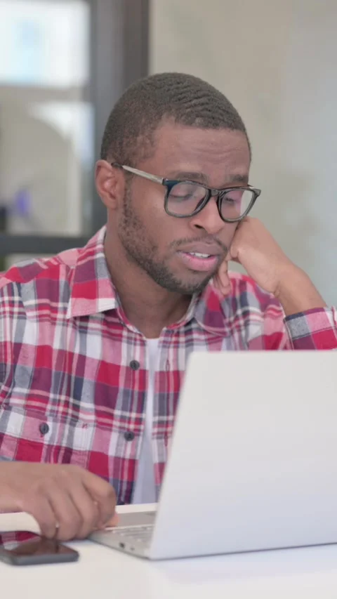 Tired African Man taking Nap While Sitting in Office with Laptop, Vertical Video Stock Footage 340040431