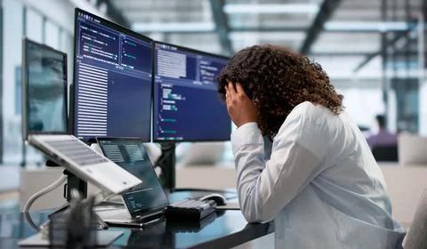 Tired African Software Engineer Rubs Head While Coding Late At Desk. Stock-Fotos