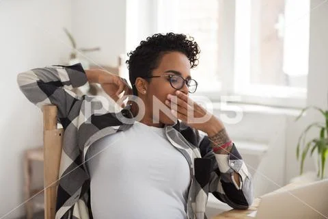 Tired African young woman sitting at office Stock Photos