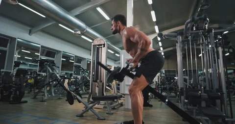 Tired and attractive athletic guy working well in a gym class very concentrated Video stock 116037969