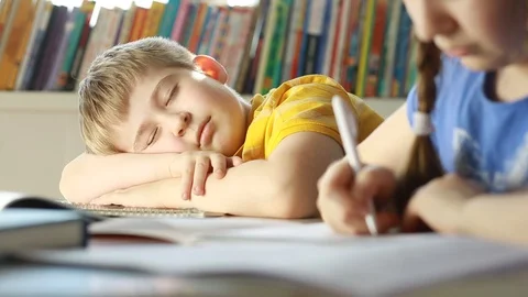  Tired and exhausted   primary school student falling asleep while studying. Stock Footage 87611534