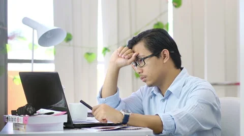 Tired and Stressed Asian Man At Work  - Slow Motion Stock Footage