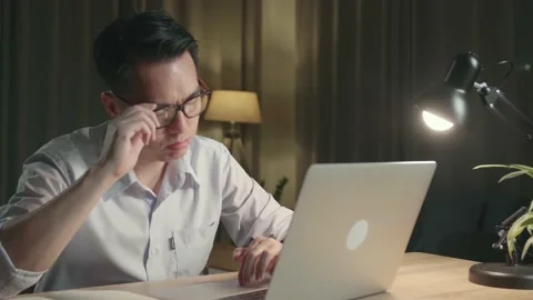 Tired Asia Man While Working From Home At Living Room At Night Stock Footage 154917699