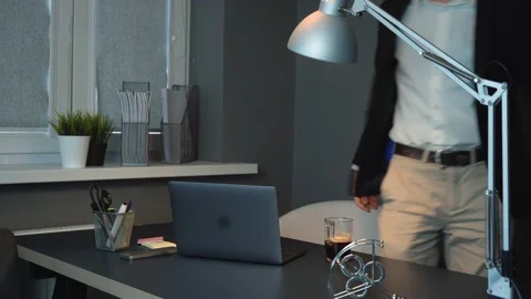 Tired Asian Man Seating at Work Drinking Coffee Happy with Selling Jumps up Stock Footage 148365639