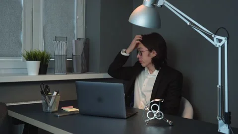 Tired Asian Man Seating at Work Drinking Coffee Thinking How to Manage to Work Stock Footage 148365810