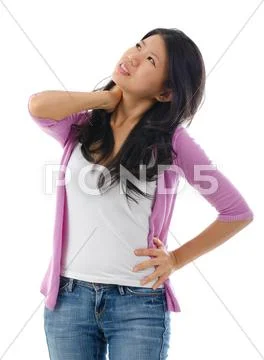 Tired asian woman having neck and shoulder pain Stock Photos