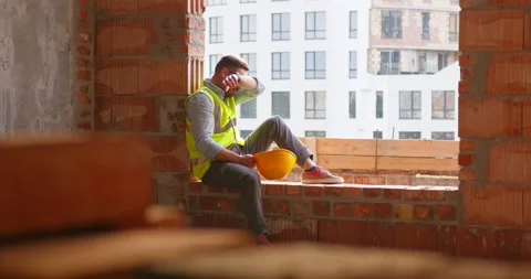 Tired Asian worker or foreman in vest takes off white helmet and wipes sweat Stock Footage 172286321