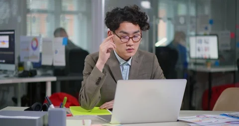 Tired asian young programmer putting off glasses Stock Footage 99250630