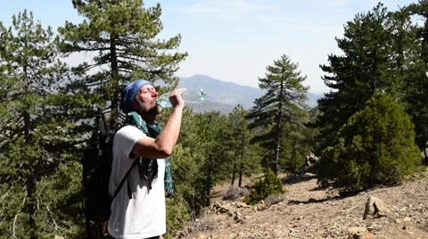 Tired bearded hiker resting, drinking water Stock-Footage 63095608
