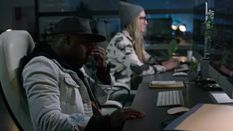 Tired Black Male Programmer Working on Code in Office at Night Stock Footage 273832691