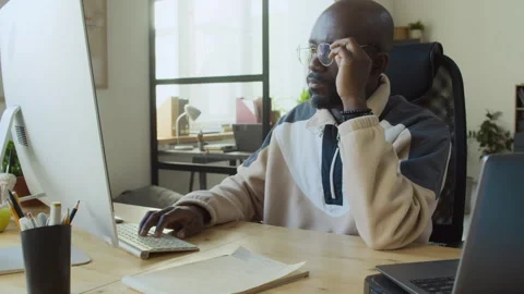 Tired Black Male Software Developer in Glasses Working on Computer Stock Footage 293122827