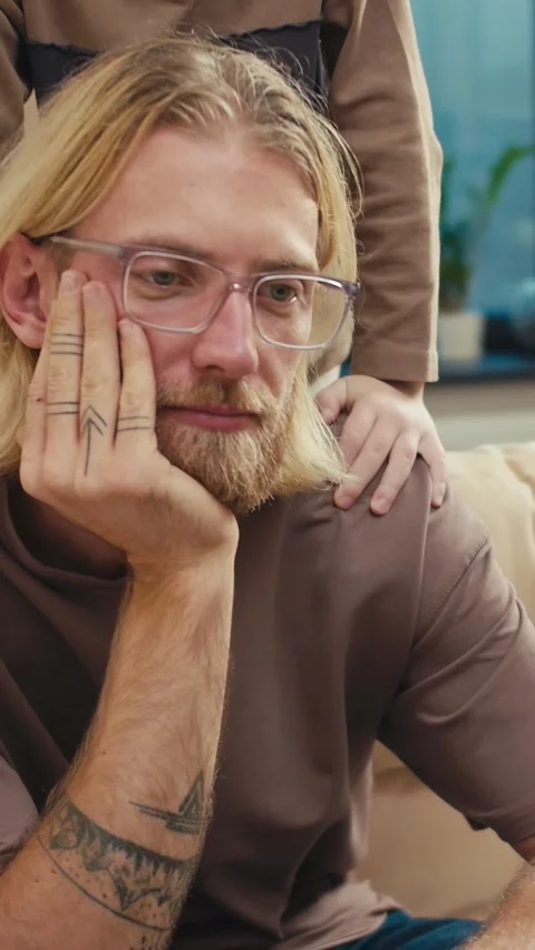 Tired blond dad in glasses does not react to the fact that his son wants Stock Footage 304854398