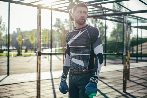 Tired boxer looking into the distance while being at the sports ground Stock Photos
