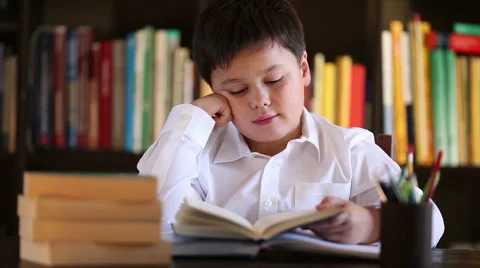 Tired boy reading Stock Footage 46025525