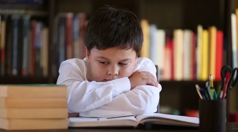 Tired boy sleeping during his studies Stock Footage 46025439
