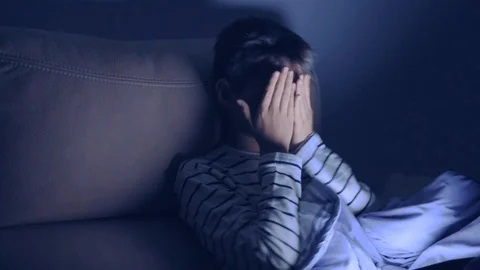 Tired boy using tablet pc at home at night. Video stock 127881542