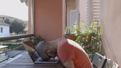 Tired boy writes on his computer then rests his head on it Stock Footage 126613220