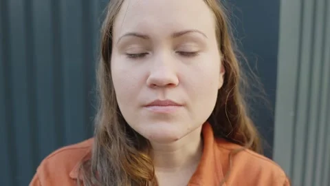 Tired brunette looking to camera and blinking a lot, close up portrait view Video stock 252746102