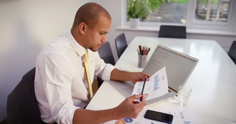Tired businessman with a concerned look having a video call on a mobile phone Stock Footage 54603545