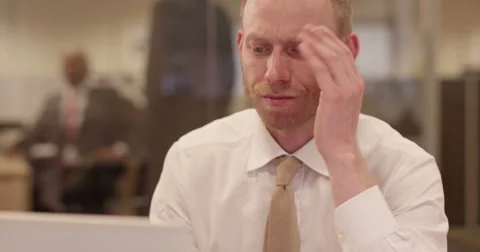 Tired businessman with a concerned look working at a modern glass office. Stock Footage
