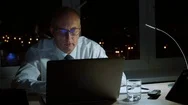 Tired Businessman Rubbing Eyes While Executive Working By Notebook In Night Stock Footage