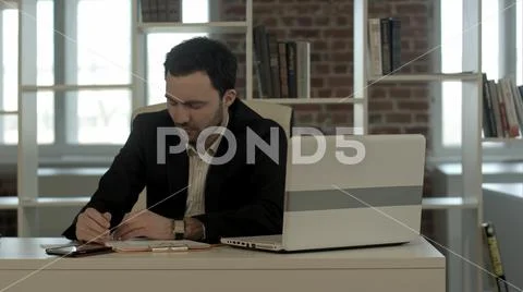 Tired businessman sleeping in office, wake up and start talking phone Stock Photos