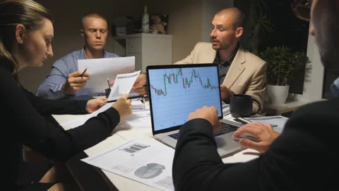 Tired colleagues sitting at table and discussing income charts and graphs Vídeo Stock 114811327