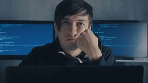 Tired computer developer and hacker is working late at night on his computer and Stock Footage 101256818