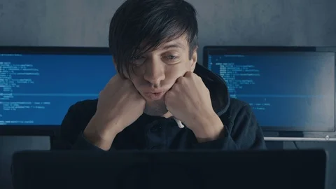 Tired computer developer and hacker is working late at night on his computer and Stock Footage 101259495