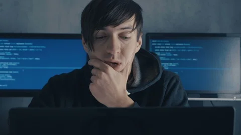 Tired computer developer and hacker is working late at night on his computer and Stock Footage 101260979