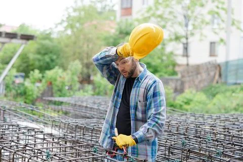 Tired construction worker removing hard hat Stock Photos