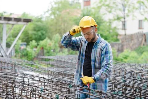 Tired construction worker removing hard hat Stock Photos