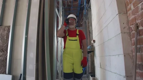 Tired construction worker walking inside reconstructing building Stock Footage 133636403