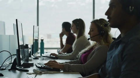 Tired customer service representative removing headset and rubbing face in call Stock Footage 109572597
