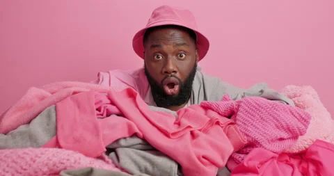 Tired dark skinned man fall asleep on pile of laundry feels exhausted of doing Stock Footage 156968306
