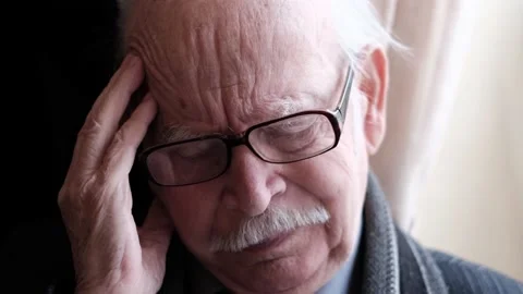 A tired, depressed old gray-haired man experiences headaches and loneliness Stock Footage 204968513
