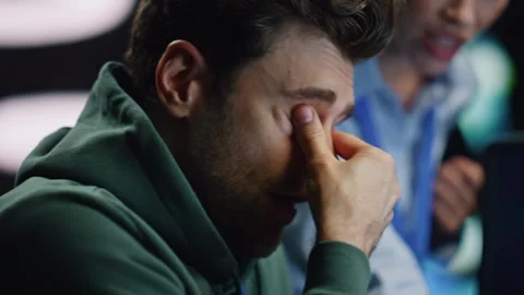 Tired developer rubbing eyes working at office late with woman colleague closeup Stock Footage 260244833