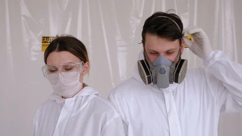 Tired doctors take off protective masks and clothing in the hospital.Coronavirus Stock Footage 128646083